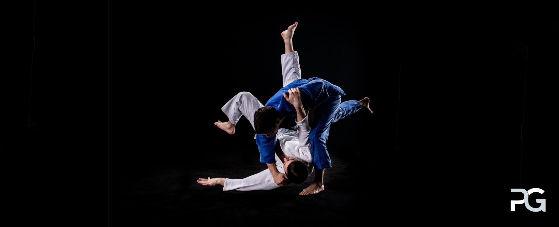 Two martial man engaging in a judo combat